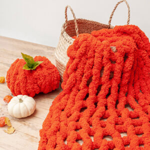 arm knitted blanket made using orange chenille 
