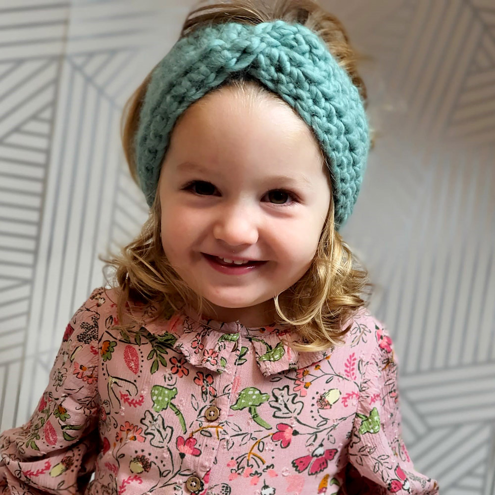 Lou models our crochet headband made using merino wool 