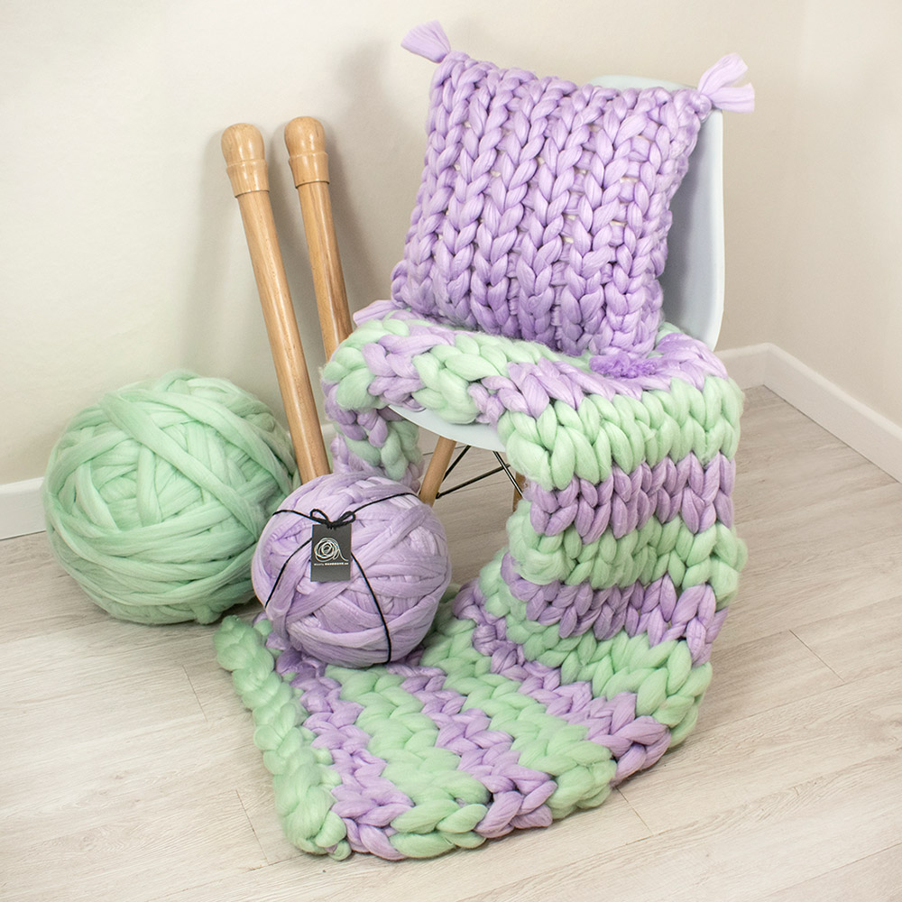 arm knitted stripe blanket using 1 kilogram of mint Mammoth yarn and 1 kilogram of lilac mammoth yarn